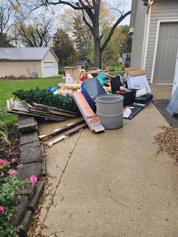 Dumpster being loaded with debris for Residential Dumpster Rental in Champlain